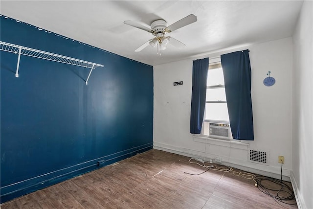 unfurnished room featuring hardwood / wood-style flooring, ceiling fan, and cooling unit