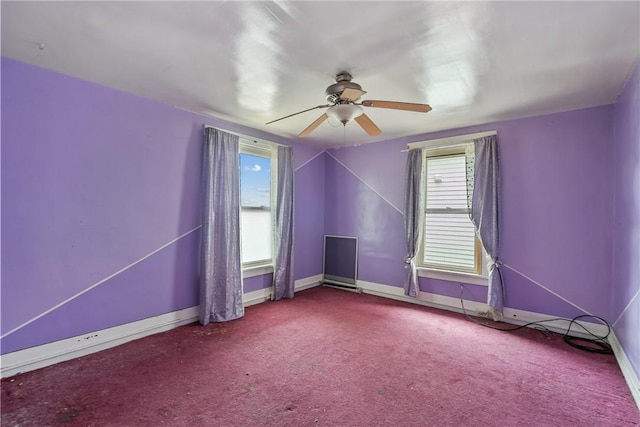 empty room with carpet flooring and ceiling fan