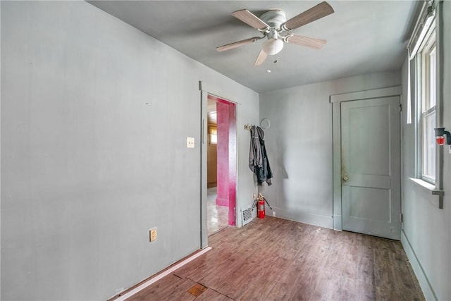 foyer with ceiling fan and hardwood / wood-style floors