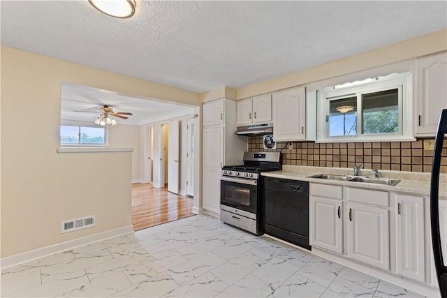 kitchen featuring dishwasher, backsplash, white cabinets, sink, and stainless steel range