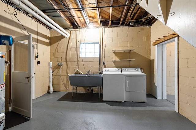 clothes washing area with washer and clothes dryer and sink