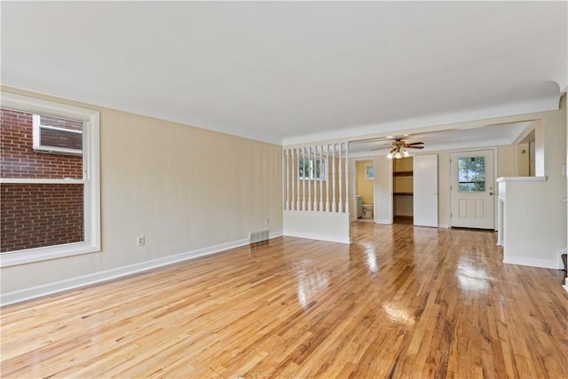 unfurnished living room with light hardwood / wood-style floors and ceiling fan