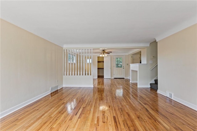 unfurnished living room with ceiling fan and light hardwood / wood-style floors