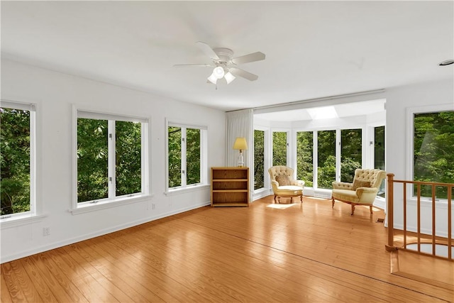 unfurnished sunroom featuring ceiling fan