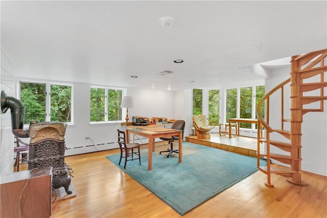 dining area with baseboard heating and light hardwood / wood-style flooring