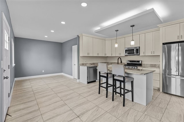 kitchen featuring stainless steel appliances, a center island, a breakfast bar area, light stone countertops, and pendant lighting