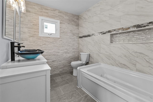 bathroom with toilet, a bathtub, tile walls, tile patterned floors, and vanity