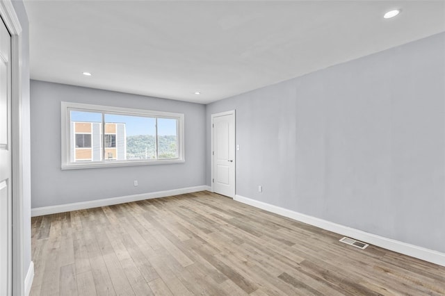 spare room featuring light hardwood / wood-style floors