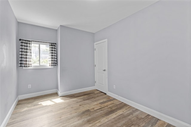 empty room with light hardwood / wood-style flooring