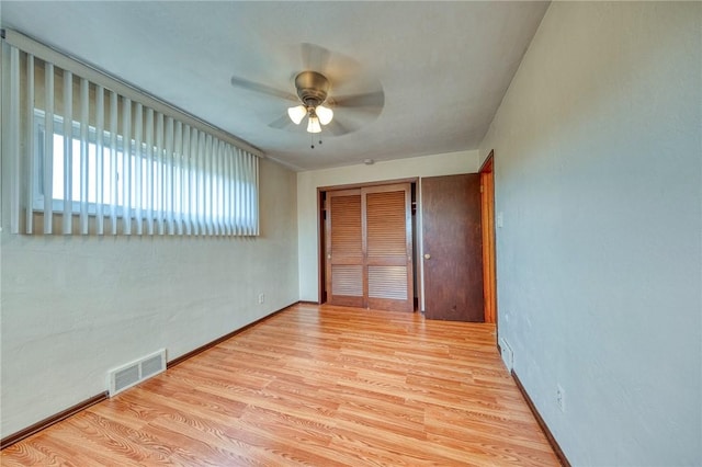 unfurnished room with ceiling fan and light wood-type flooring