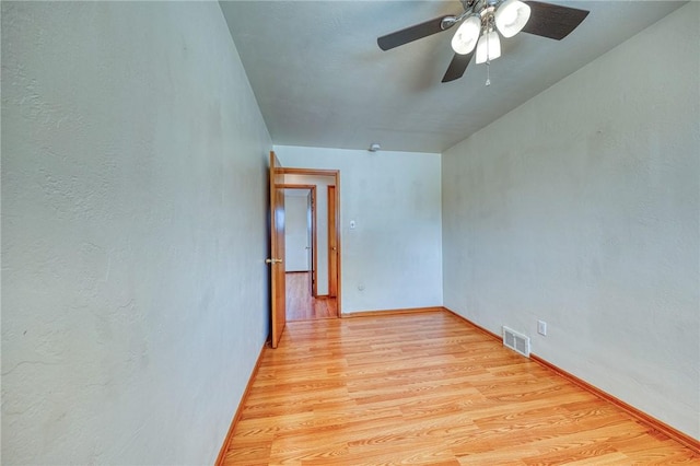 empty room featuring ceiling fan and light wood-type flooring