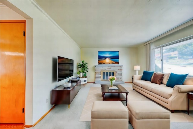 living room featuring a stone fireplace and ornamental molding