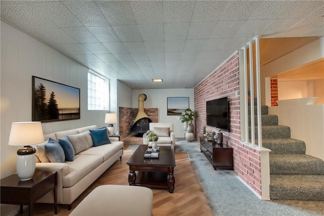 living room with a wood stove and carpet floors