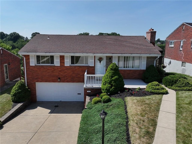 view of front of property with a garage and a front lawn