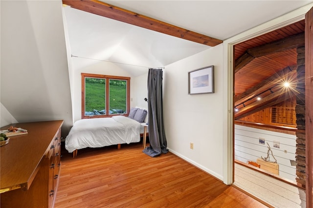 bedroom with lofted ceiling and light wood-type flooring