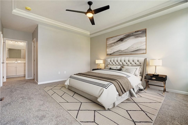 bedroom with ceiling fan, ornamental molding, light carpet, and a tray ceiling