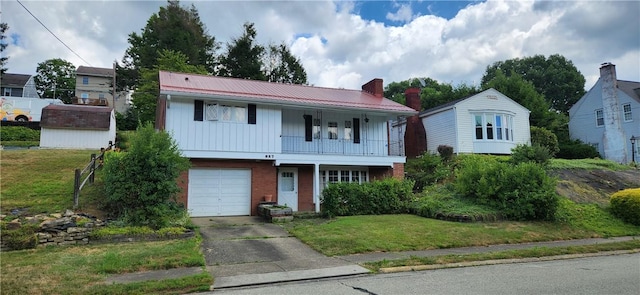 view of front of house with a front yard and a garage