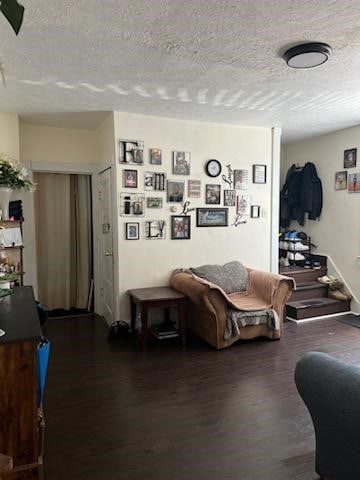 living room with a textured ceiling and hardwood / wood-style flooring