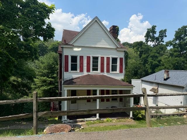 rear view of property featuring a porch