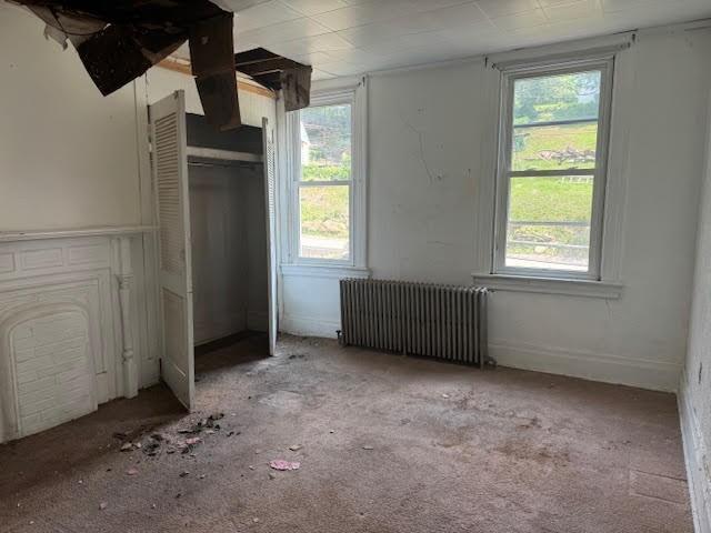 unfurnished bedroom with radiator heating unit