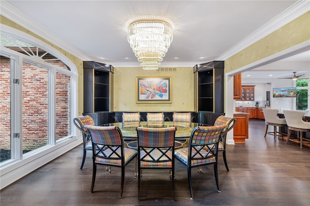 dining area featuring ceiling fan with notable chandelier, crown molding, and dark wood-type flooring