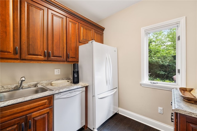 kitchen featuring sink, dark wood-type flooring, and white appliances