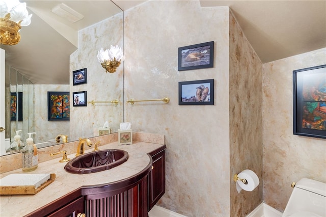 bathroom featuring vanity and toilet