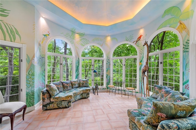 sunroom featuring a tray ceiling