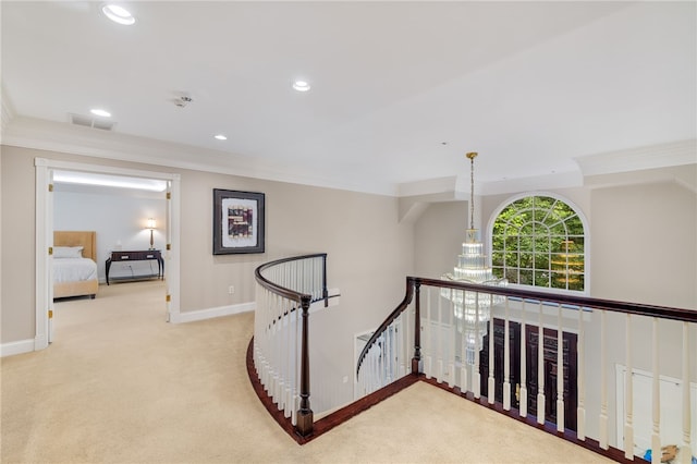 hall with light colored carpet and ornamental molding