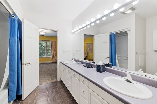 bathroom with tile patterned flooring, vanity, and shower / tub combo with curtain