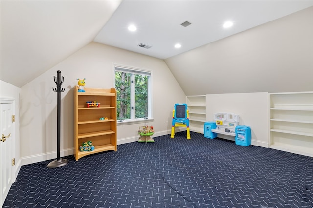 rec room with dark colored carpet and lofted ceiling