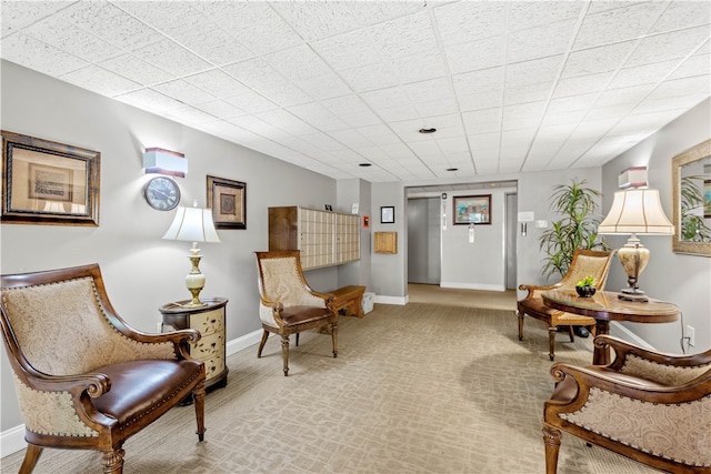 sitting room featuring carpet floors and elevator