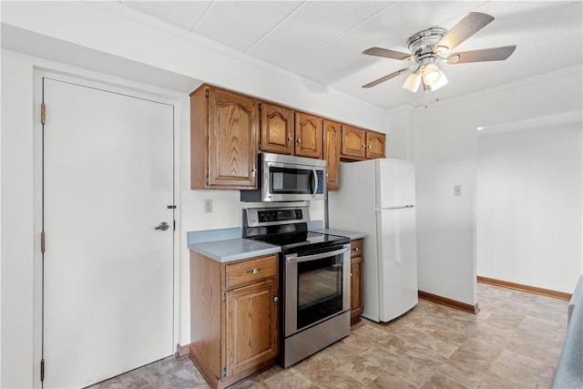 kitchen featuring light tile flooring, ceiling fan, and stainless steel appliances