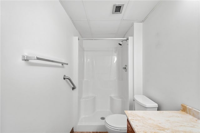 bathroom with walk in shower, vanity, and toilet