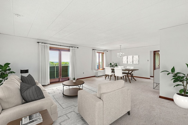 carpeted living room featuring an inviting chandelier