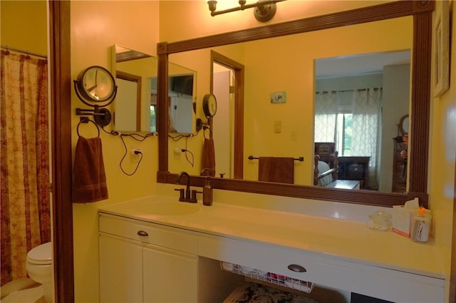 bathroom featuring toilet and vanity