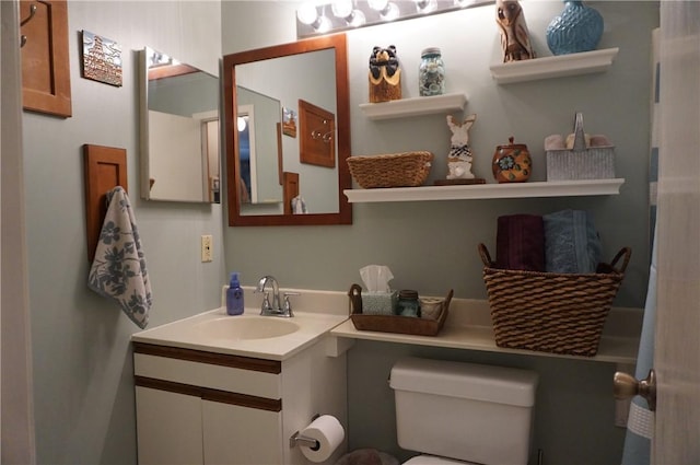 bathroom with toilet and vanity