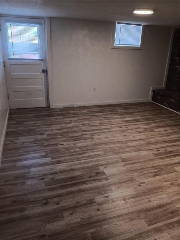 basement with dark hardwood / wood-style floors