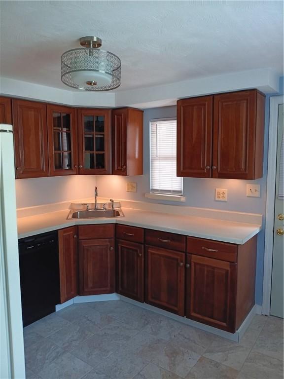 kitchen with dishwasher, white fridge, and sink