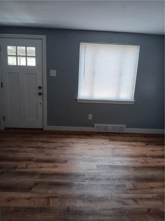 entryway with dark hardwood / wood-style flooring and plenty of natural light