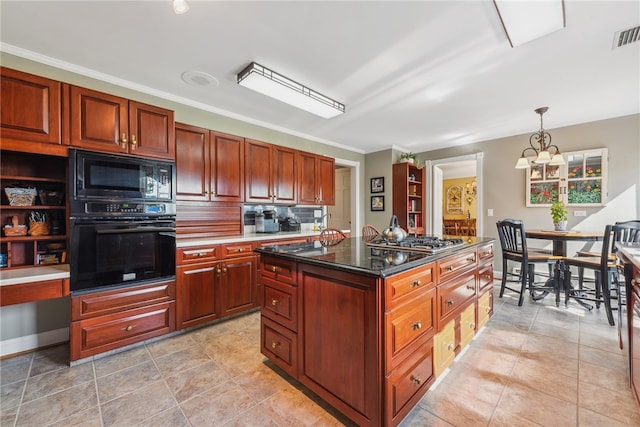 kitchen with decorative light fixtures, black appliances, backsplash, a kitchen island, and light tile floors