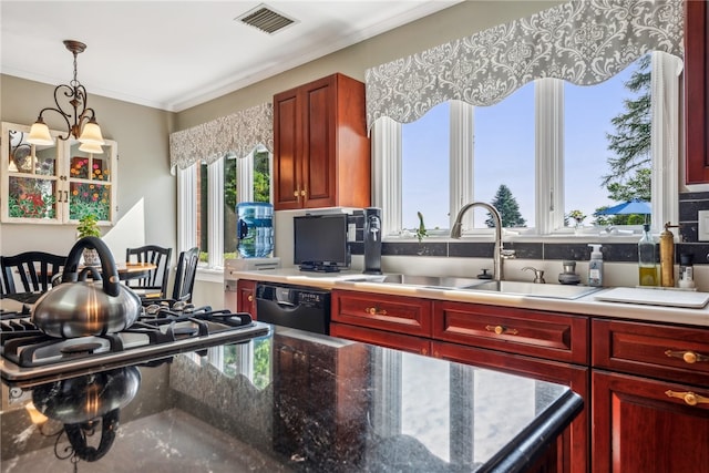 kitchen with dishwasher, pendant lighting, backsplash, sink, and a chandelier