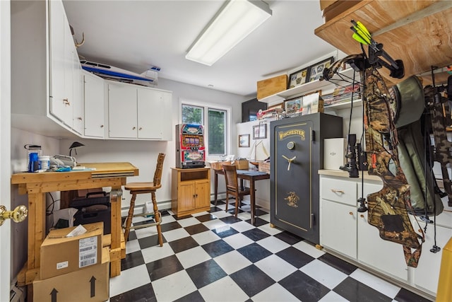 kitchen with tile floors, white cabinets, and a baseboard radiator