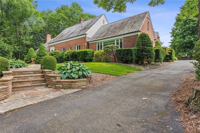 new england style home with a front yard