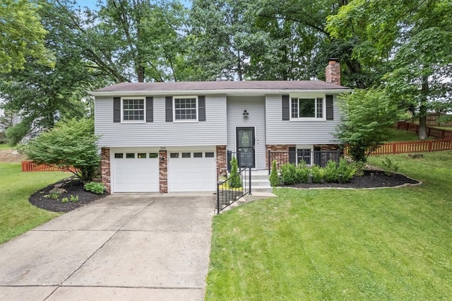 raised ranch with a garage and a front yard