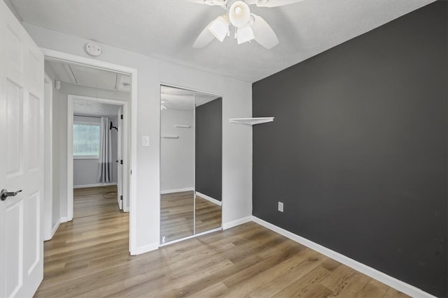 unfurnished bedroom with a closet, ceiling fan, and light hardwood / wood-style flooring