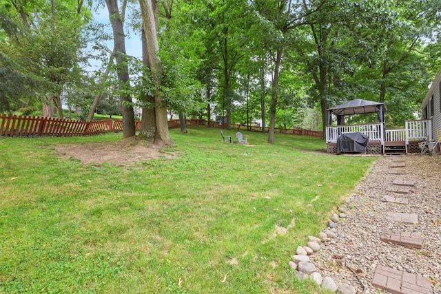 view of yard with a wooden deck and a gazebo