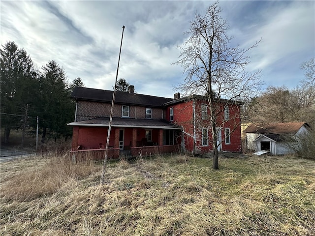 rear view of house with an outdoor structure