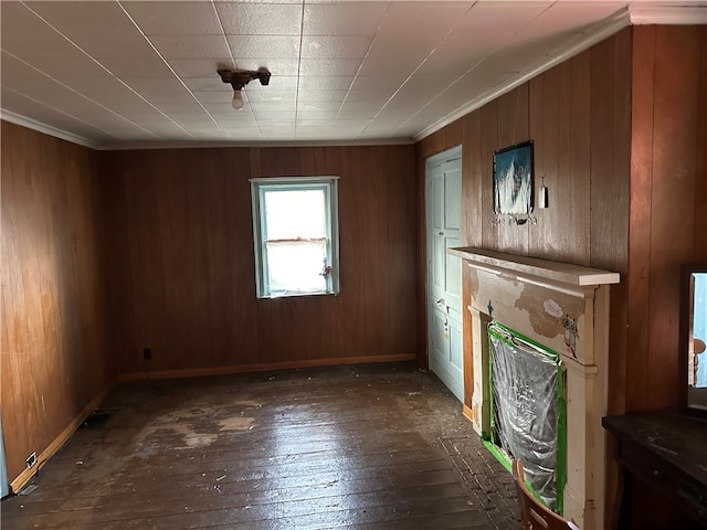 unfurnished living room featuring wood walls and hardwood / wood-style floors