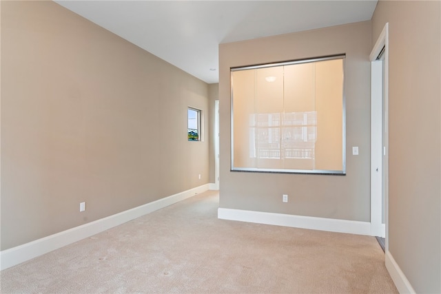 unfurnished bedroom with a closet and light colored carpet